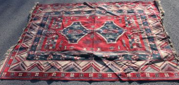 An early to mid 20th century Islamic rug on red background, geometric patterns,