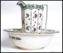 An early 20th century Burleigh Ware chintz pattern large washbowl basin and jug being stamped to