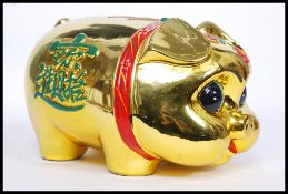A 20th century Chinese ceramic statue money box in the form of a pig,