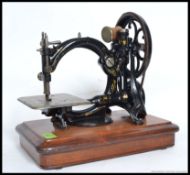 A 19th century Wilcox and Gibbs hand sewing machine raised on a mahogany plinth with sewing plate