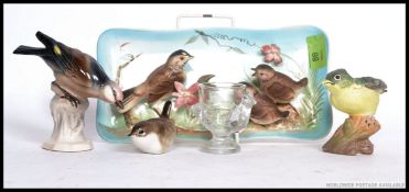 An unusual ceramic wall plaque cast in relief with British birds.