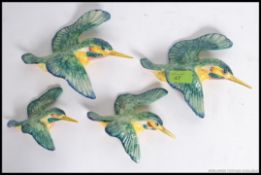 A set of 4 Beswick ceramic Kingfisher wall mounted polychrome figurines. Stamped to verso.