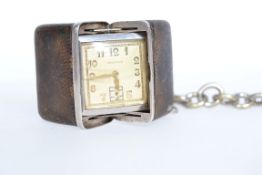 A 1930's Art Deco Sportank silver and snakeskin purse watch complete with white metal albert fob