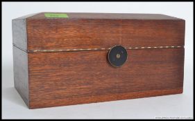 A good quality mahogany jewellery box of sarcophagus form having unusual  swivel lock to front.