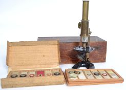 A Victorian microscope having brass telescopic lens with gilt metal base having plate slides in