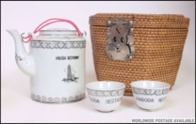 A 20th century Chinese ' Pagoda Restaurant ' tea for 2 service in whicker basket.