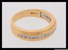 A 9ct gold and diamond half eternity ring set with 25pt diamonds. Marked 375. Weight 3.6g. Size L.