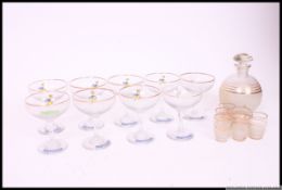 A collection of vintage Babycham glasses ( 8 total ) together with a frosted liqueur decanter and