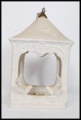 A large ceramic bird feeder of lantern shape embellished with birds to the sides having chain atop.