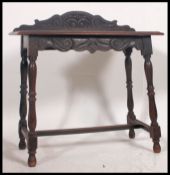 A 19th century Jacobean revival carved occasional / side table raised on turned and block legs