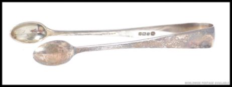 A pair of hallmarked solid silver sugar tongs. 23.