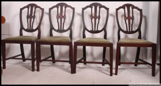 A set of 4 Georgian style mahogany hepplewhite dining chairs with shield backs,