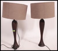 2 contemporary table lamps with large pendant shades together with another modernist shade .