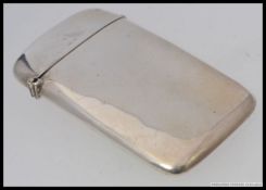 A good quality silver hallmarked cigarette case being bow shaped for the pocket with hinged lid by