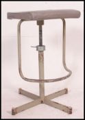 A superb vintage industrial machinists factory stool with adjustable height and unusual footrest.