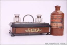 A Victorian ebonised mahogany desk tidy inkwell with twin glass wells and   carry handle to centre.