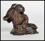 A well detailed small early 20th century bronze Japanese oriental figure.