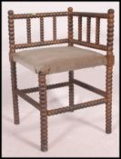 An early 20th century William & Mary revival corner chair being raised on bobbin turned supports