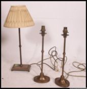 A collection of three antique style neo classical metal table lamps with shades