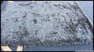 A large contemporary floor rug with deep pile in forest green colours ( description to be updated