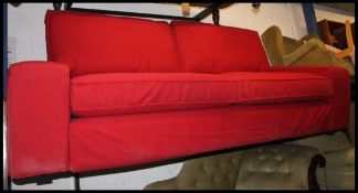A contemporary red block sofa settee upholstered in a dark red fabric - ex bbc James Martin show.