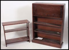A 1940's Utility type oak students bureau having fall front over bookcase cabinet beneath.