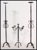 A set of 3 large medieval style cast iron candelabra candlesticks - stands to include floor