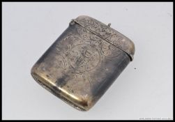 A large silver hallmarked vesta being rococo chased with hinged top, monogram to cartouche centre.