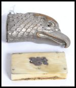 A vintage mid century silver metal match vesta styled as an Eagle along with a bone vesta
