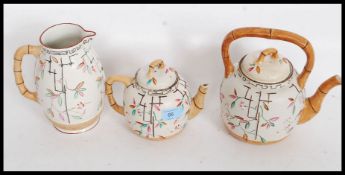 A Victorian Majolica large and small teapot together with matching water Jug in a bamboo style