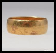 An 18ct gold band ring bearing Birmingham hallmarks for MW. Total weight 4.