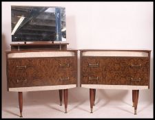 A 1950's melamine dressing table and matching chest of drawers Both raised on tapered legs with