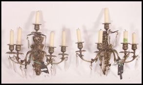 A good pair of brass five point candelabra wall sconces having glass drop lets