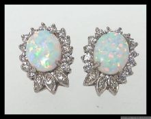 A pair of 925 silver CZ and Opalite earrings in a stylised Art Nouveau crown setting. Measures 1.