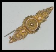 A Victorian 9ct gold ladies oval bar brooch with photo panel back,