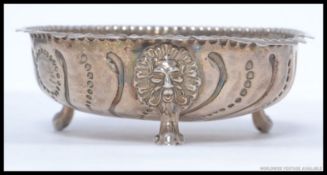 A hallmarked silver bowl on ball and claw feet, Date letter G.