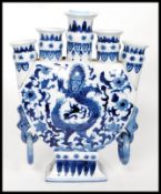 A Chinese blue and white five planter moon vase bearing dragons and tress to each side.