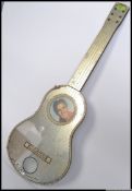 A vintage Elvis related mirror in the shape of a guitar, with notation to base. Wall hanging.