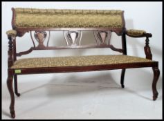 An Edwardian mahogany and marquetry inlaid salon sofa.