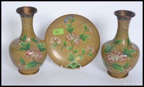 A pair of Chinese cloisonne enamel baluster vases having floral spray decoration along with a