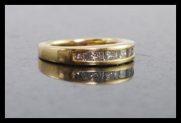 An 18ct gold and diamond half eternity ring. The sqaure and baguette cut stones approx 50pnts.