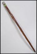 A silver knop top walking stick.