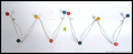 A pair of retro 1950's atomic / sputnik style wall mounted coat racks with colourful finial ends
