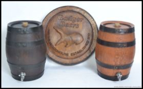 A vintage style advertising beer barrel advertising Badger Beer along with a pair of bar top