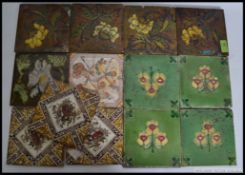 A collection of late 19th and early 20th century fireside ceramic tiles,