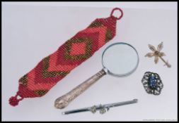 A silver hallmarked puzzler magnifying glass  with rococo handle having hallmarks for Harrison