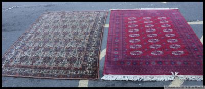 Two floor rugs of Middle Eastern design the first having a Kashon Super label applied,