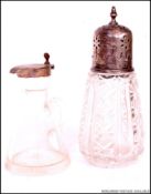 A silver and cut glass hallmarked sugar sifter together with a silver and glass oil bottle.