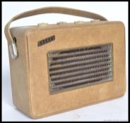 A vintage 1950's Hacker Herald portable radio having cream vinyl cover.