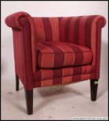 A 20th century contemporary tub armchair raised on tapered legs with striped upholstery.